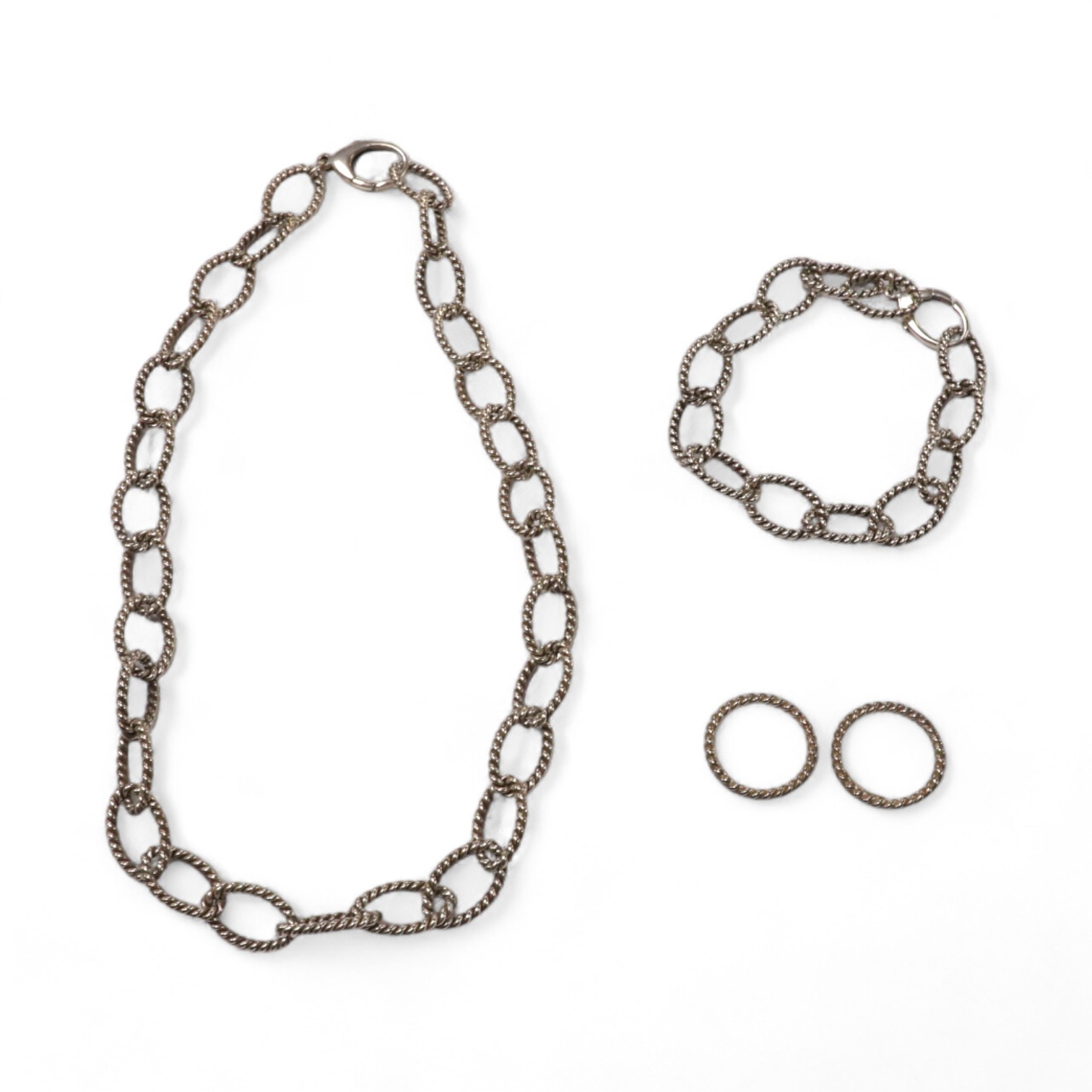 A modern Italian Tiffany & Co 925 suite of jewellery, of rope twist design, comprising a necklace, 42cm, bracelet, 18cm and two rings, size O/P and O. Condition - fair to good